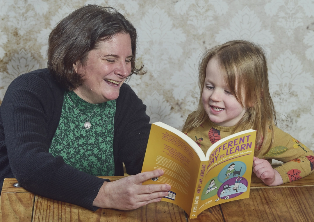 Naomi and Child reading A Different Way To Learn